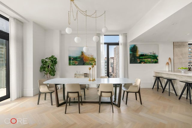 dining space featuring light parquet flooring