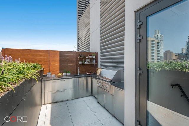 view of patio featuring an outdoor kitchen, sink, and grilling area