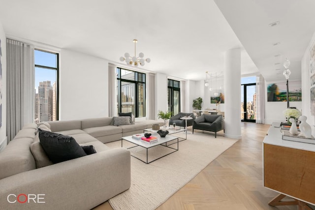 living room with light parquet flooring and a notable chandelier