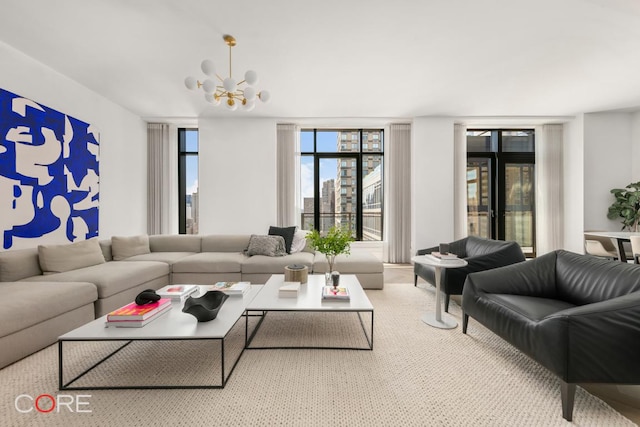 carpeted living room with an inviting chandelier