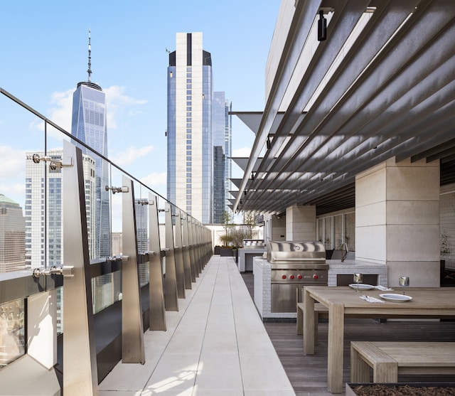 view of patio with area for grilling, grilling area, and a city view