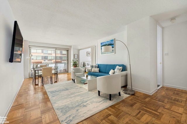 living room featuring parquet flooring and a textured ceiling