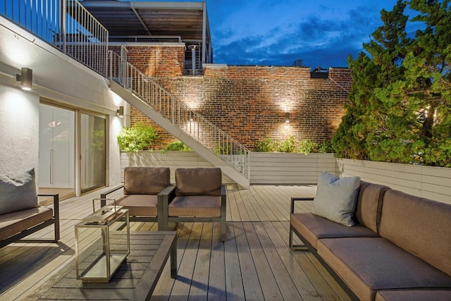 deck at dusk with an outdoor hangout area