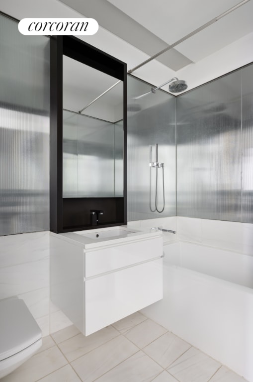 full bathroom featuring tile patterned floors, toilet,  shower combination, and vanity