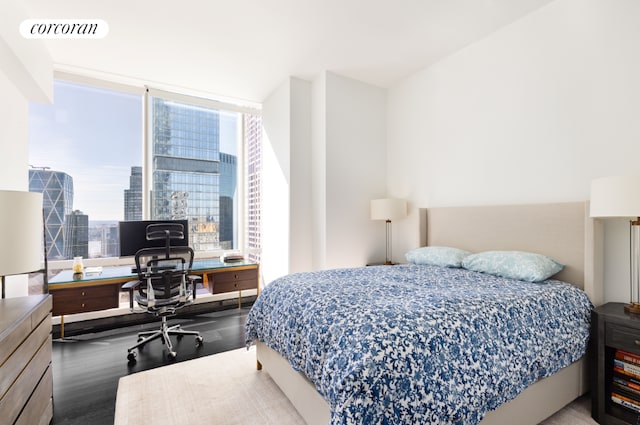 bedroom with hardwood / wood-style floors and multiple windows