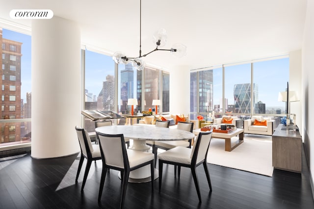 dining area featuring dark hardwood / wood-style flooring, a notable chandelier, and a wall of windows