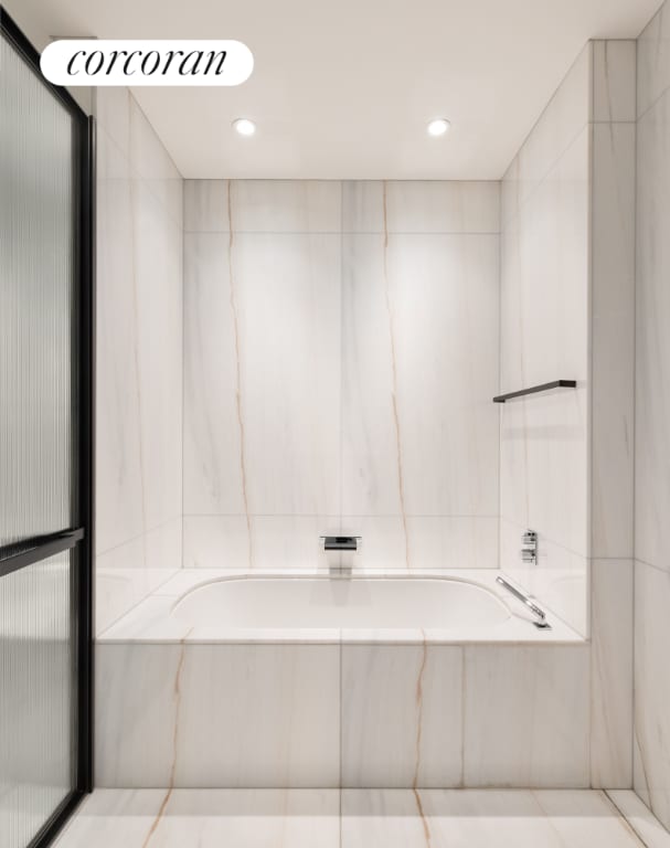 bathroom featuring independent shower and bath and tile walls