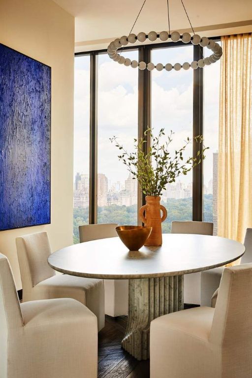 dining area featuring wood-type flooring and floor to ceiling windows