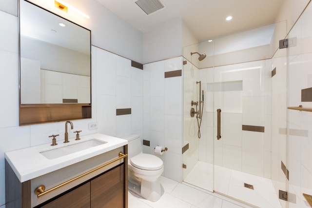 bathroom with a shower with door, toilet, and vanity