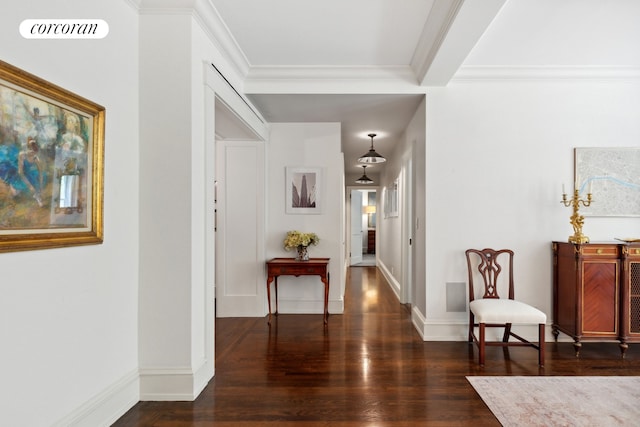 hallway with baseboards, crown molding, visible vents, and wood finished floors