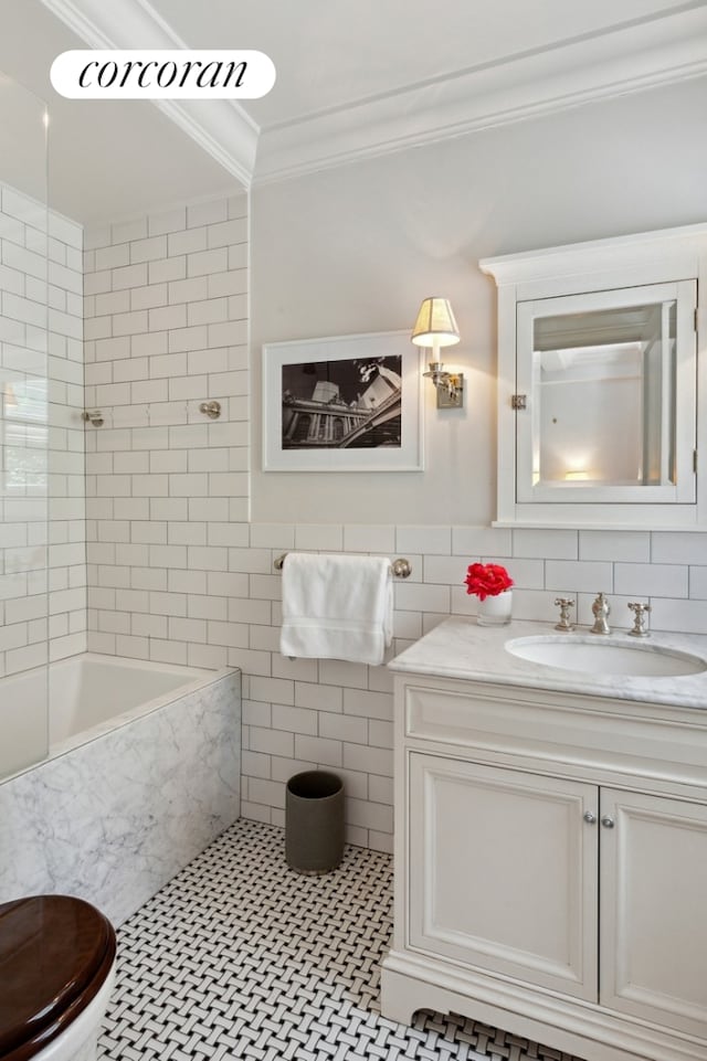 full bathroom with shower / washtub combination, tile walls, ornamental molding, vanity, and tile patterned floors