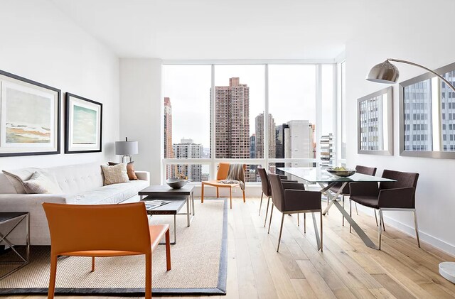 325 Lexington Ave Unit 27-D, New York City, NY 10016 - dining area with floor to ceiling windows, plenty of natural light, light wood finished floors, and a city view