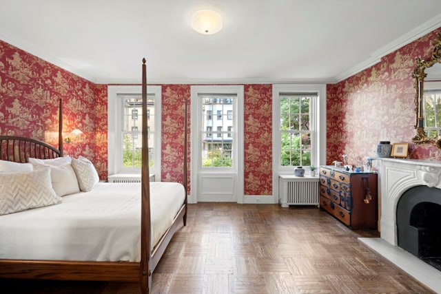 bedroom with parquet flooring, ornamental molding, and radiator