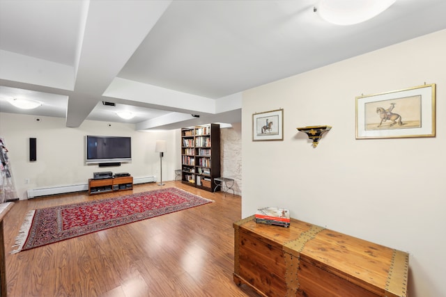 living room featuring a baseboard heating unit and wood-type flooring