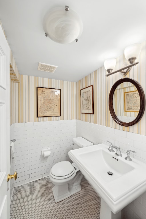 bathroom featuring tile patterned flooring, sink, and toilet