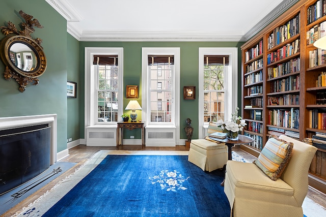 unfurnished room featuring ornamental molding and radiator