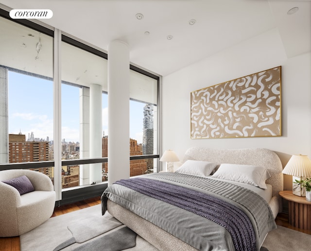 bedroom featuring multiple windows, hardwood / wood-style flooring, and expansive windows