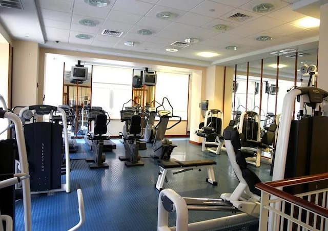 exercise room featuring a drop ceiling