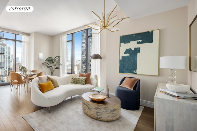 430 E 58th St Unit 19B, New York City, NY 10022 - living area featuring a view of city, hardwood / wood-style floors, plenty of natural light, and floor to ceiling windows