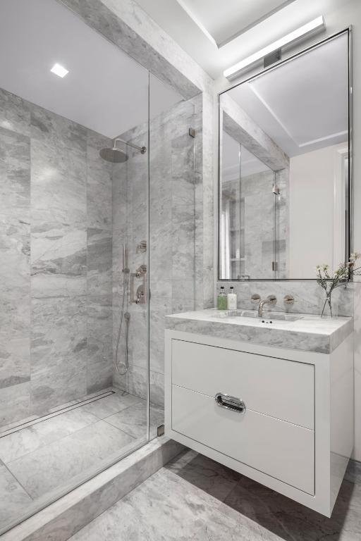 bathroom featuring vanity and a tile shower