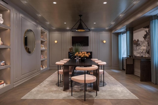 dining space with wood-type flooring and built in features