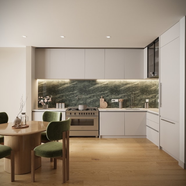 kitchen with tasteful backsplash, sink, white cabinets, and range with gas cooktop