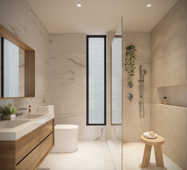 bathroom featuring vanity, a tile shower, and tile walls