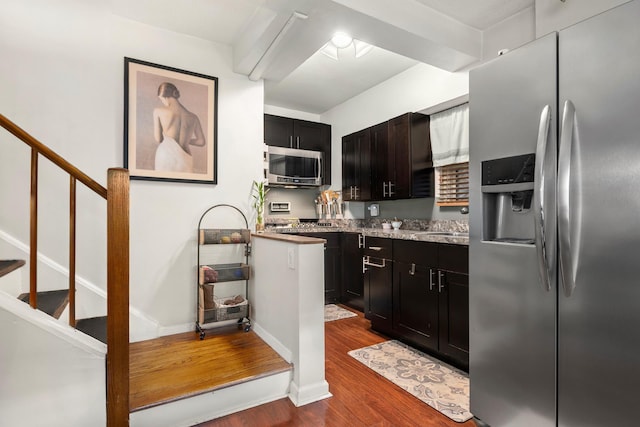 kitchen featuring dark cabinets, baseboards, appliances with stainless steel finishes, and dark wood-type flooring