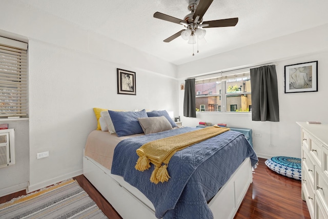 bedroom featuring ceiling fan, baseboards, and wood finished floors