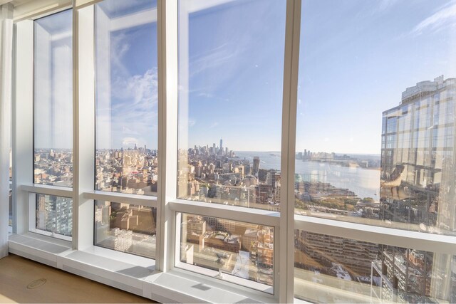 unfurnished sunroom featuring a water view