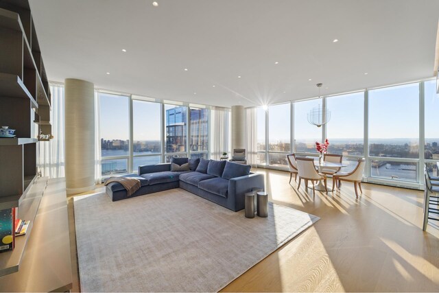 living room with expansive windows and a water view