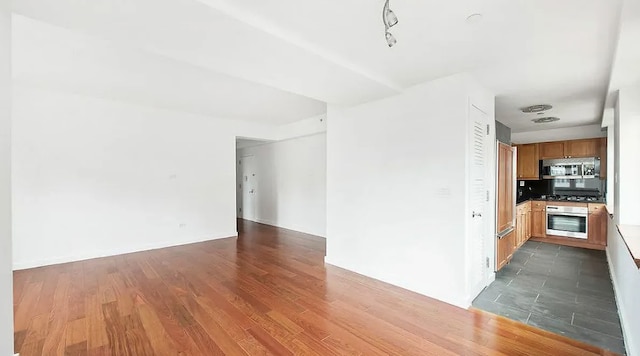 unfurnished living room with dark hardwood / wood-style flooring