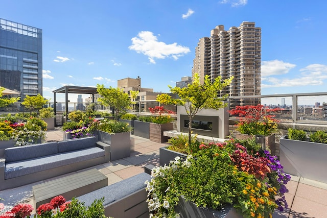 300 E 40th St Unit 4B, New York City, NY 10016 - balcony featuring an outdoor living space with a fireplace, a view of city, and a patio