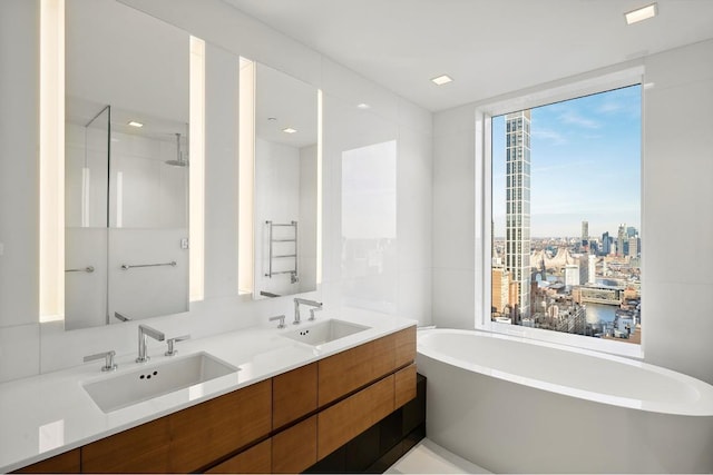 bathroom featuring independent shower and bath and vanity