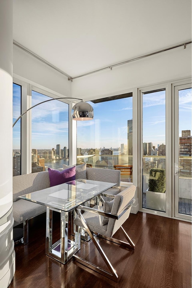 dining area with a city view and wood finished floors