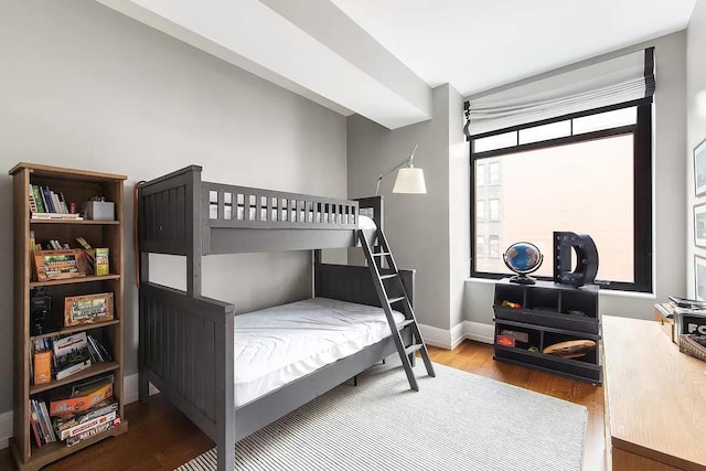 bedroom featuring baseboards and wood finished floors