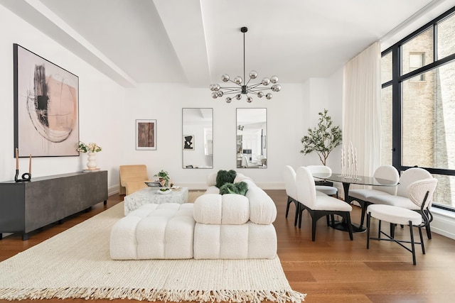 interior space featuring baseboards, wood finished floors, and a chandelier