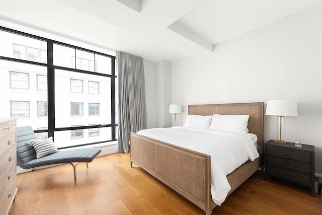 bedroom with light wood-style flooring and multiple windows