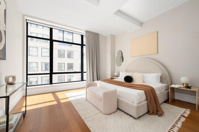 bedroom featuring baseboards and wood finished floors