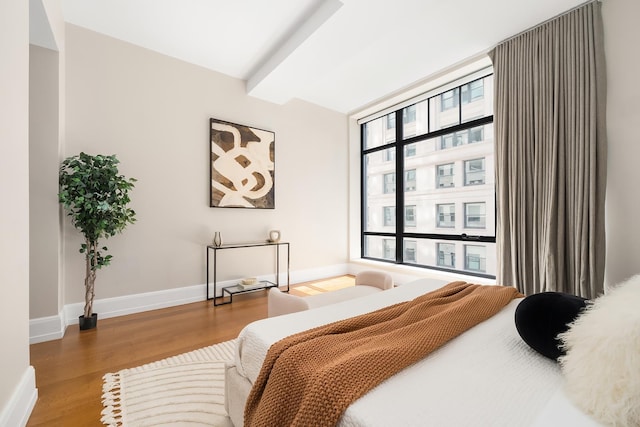 bedroom with baseboards and wood finished floors