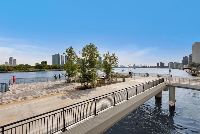 view of dock featuring a city view and a water view