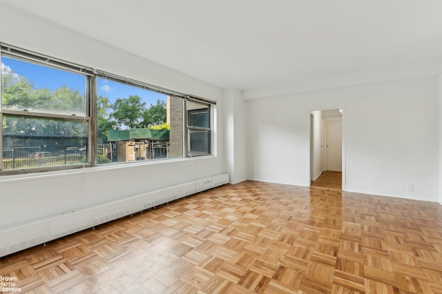 unfurnished room with a baseboard radiator
