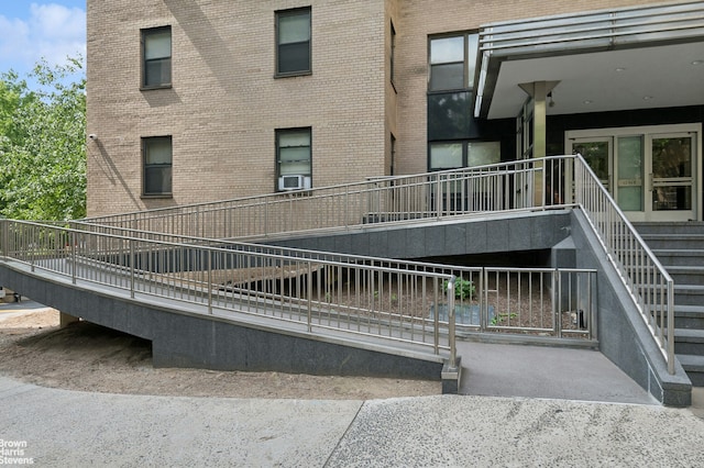 exterior space featuring brick siding and cooling unit