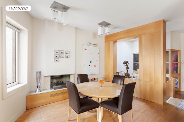 dining space with light hardwood / wood-style floors