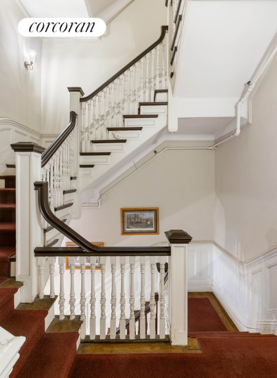 stairs featuring hardwood / wood-style floors and a towering ceiling