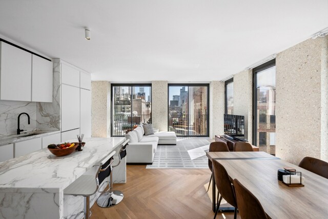 living room with light hardwood / wood-style floors and floor to ceiling windows