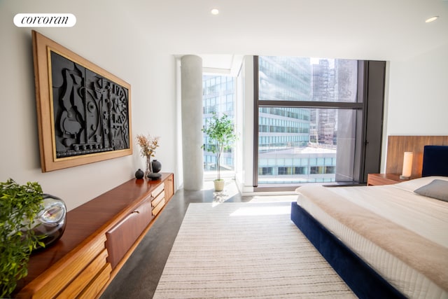 bedroom with a wall of windows and access to outside