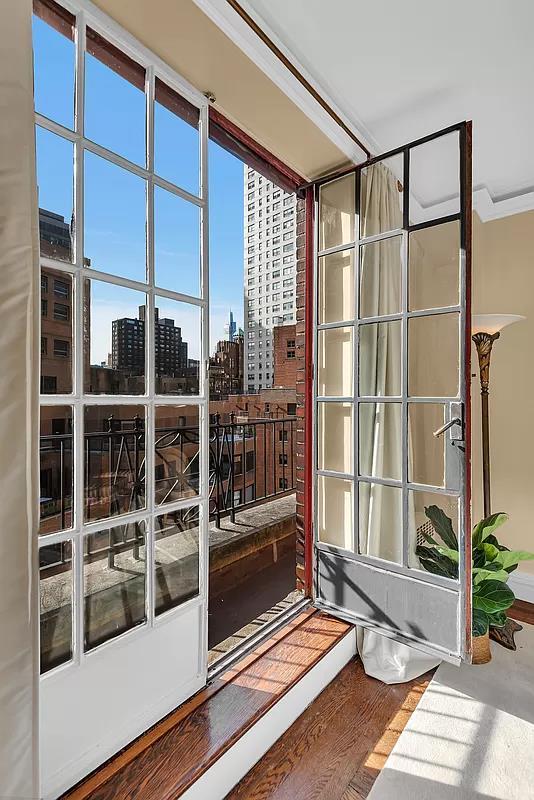 doorway to outside featuring a view of city and wood finished floors