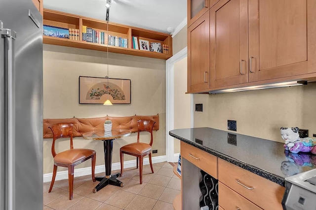 kitchen with breakfast area, light tile patterned floors, high end refrigerator, and open shelves