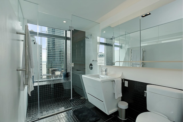 full bath featuring a stall shower, vanity, and toilet